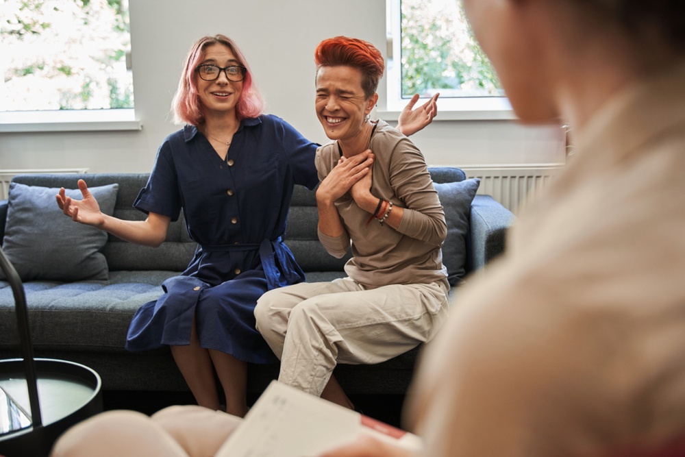 LGBTQ couple in Vancouver supporting each other during therapy for life transitions